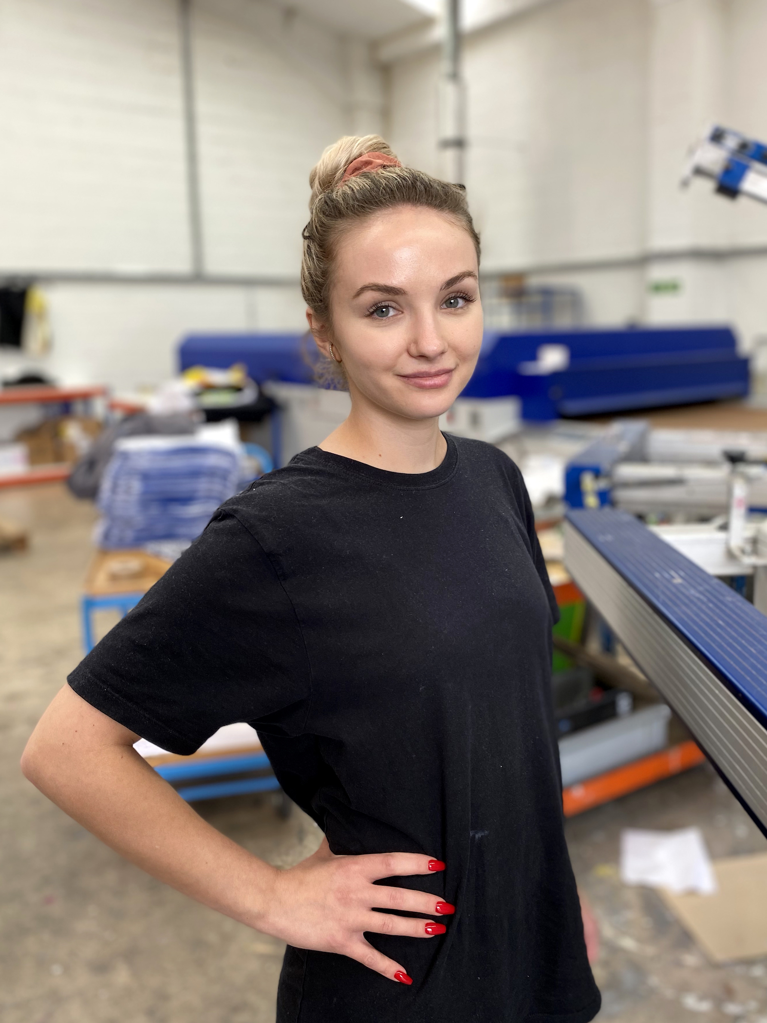 Angelika standing in our screen printing department