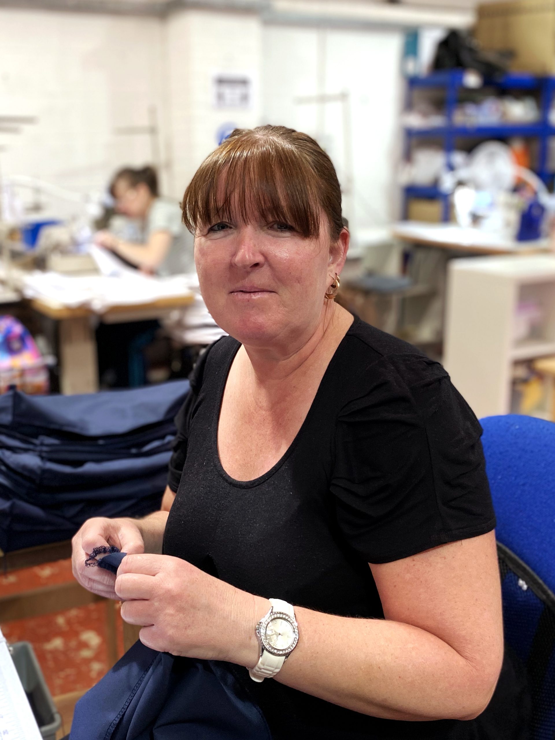 Sharon sitting in the sewing department, wrexham, UK